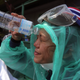 A protestor washes tear gas out of her eyes.